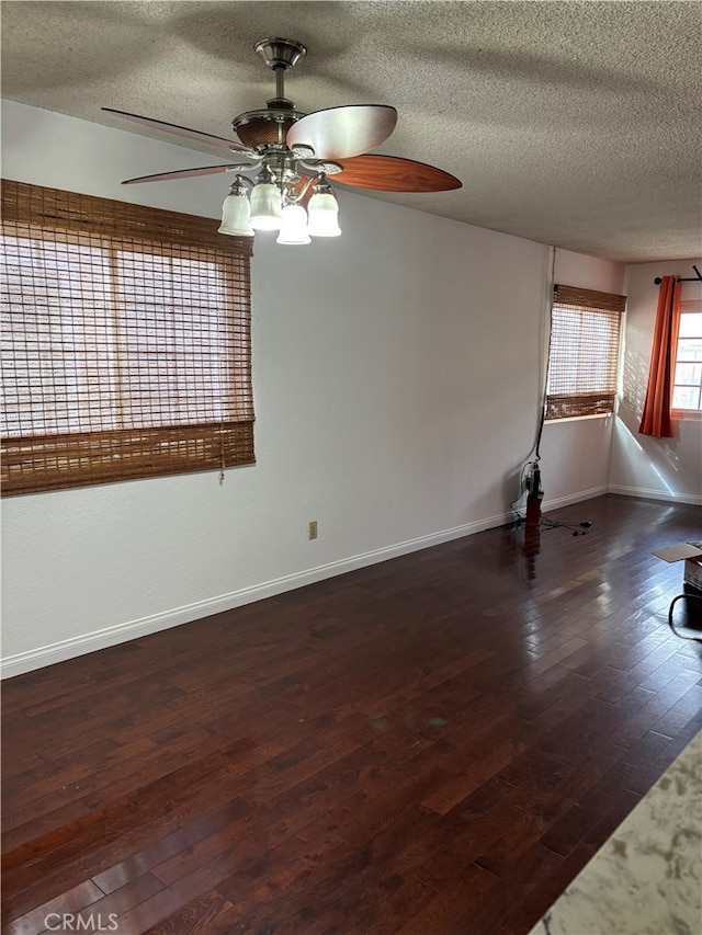 unfurnished room featuring a textured ceiling, dark hardwood / wood-style floors, and ceiling fan