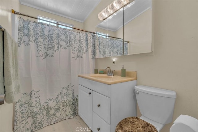 bathroom with vanity, ornamental molding, tile patterned flooring, and toilet