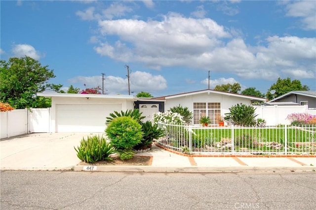 ranch-style home featuring fence, stucco siding, an attached garage, and driveway