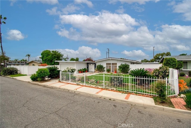 ranch-style house featuring a fenced front yard and stucco siding