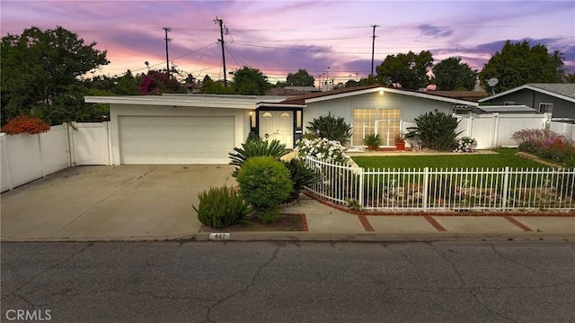 single story home with fence private yard, a garage, stucco siding, concrete driveway, and a lawn