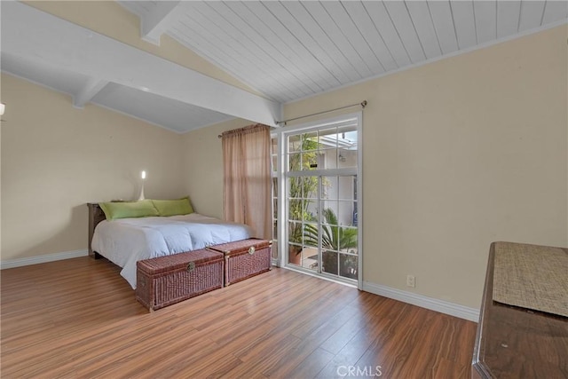 bedroom featuring wooden ceiling, baseboards, vaulted ceiling with beams, and wood finished floors