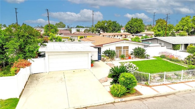 view of front facade with concrete driveway, an attached garage, fence private yard, and a front yard
