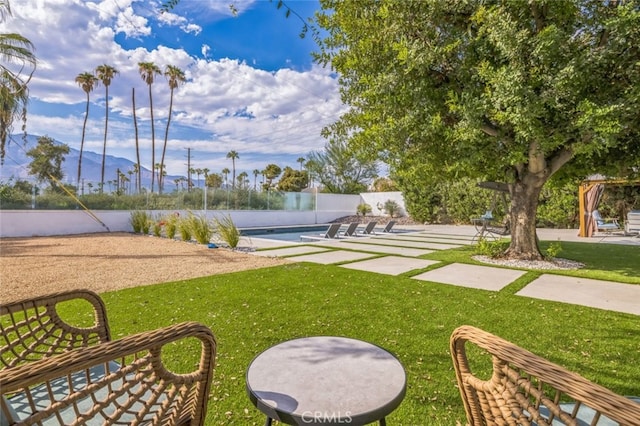 surrounding community with a lawn, a pool, and a patio