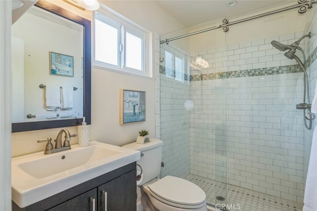 bathroom featuring walk in shower, vanity, and toilet