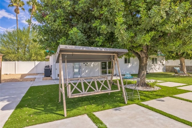 rear view of property featuring a lawn