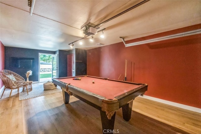 recreation room with a textured ceiling, billiards, and hardwood / wood-style floors