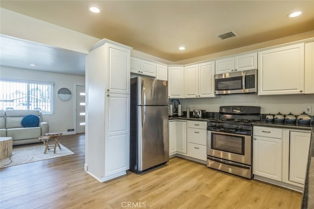 kitchen featuring light wood-type flooring, white cabinetry, and appliances with stainless steel finishes