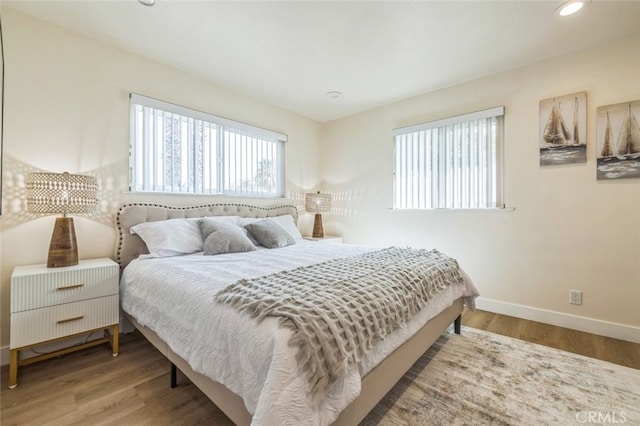 bedroom with hardwood / wood-style flooring