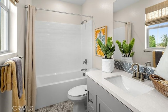 full bathroom with shower / bath combo with shower curtain, vanity, and toilet