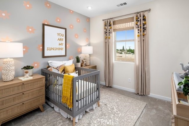 carpeted bedroom with a nursery area