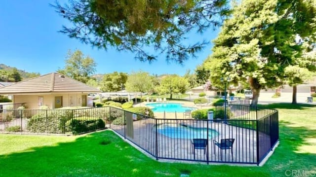 view of pool with a yard and a patio