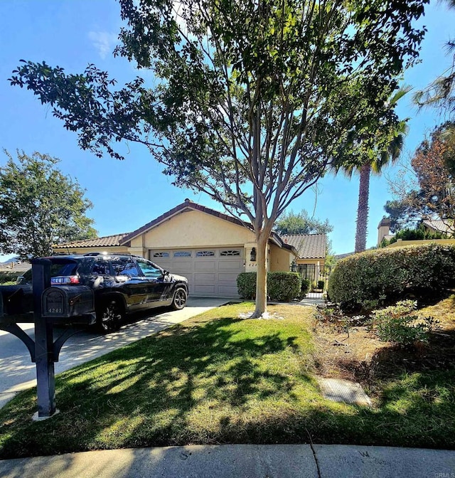 single story home featuring a front yard and a garage