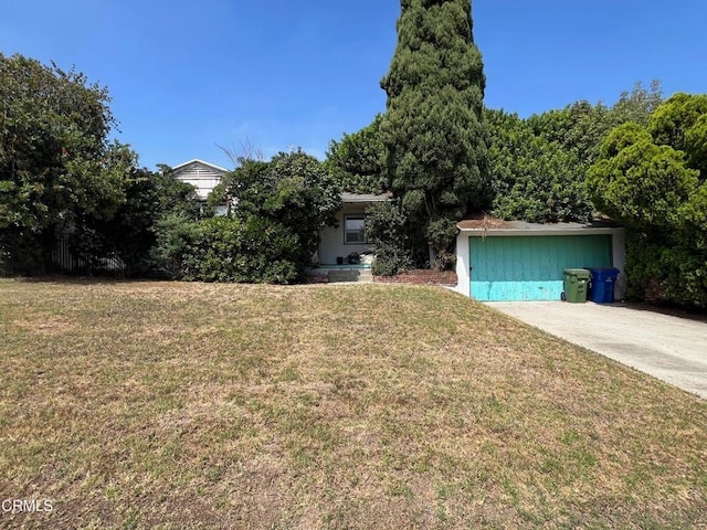 view of front of home with a front lawn and a garage