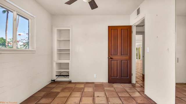 tiled empty room with ceiling fan