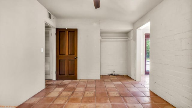 unfurnished bedroom featuring ceiling fan, lofted ceiling, and light tile patterned flooring