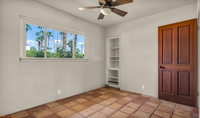 unfurnished room with ceiling fan and light tile patterned floors