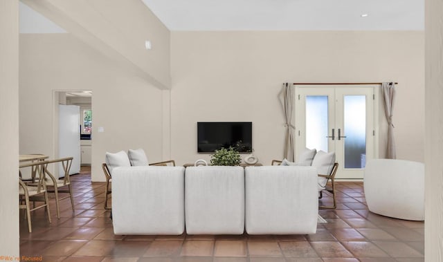 tiled living room featuring french doors and a towering ceiling