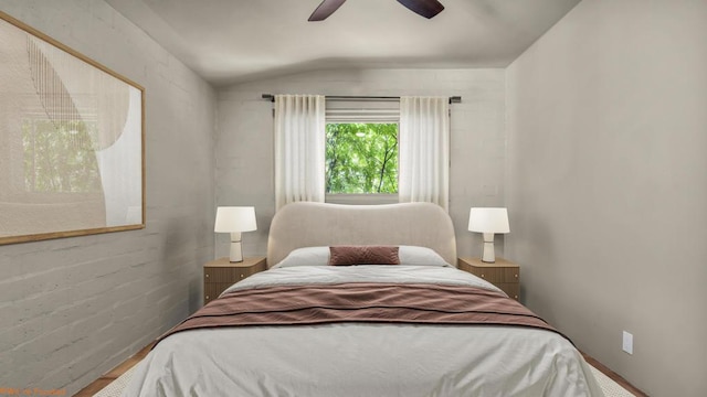 bedroom with hardwood / wood-style flooring, ceiling fan, and lofted ceiling