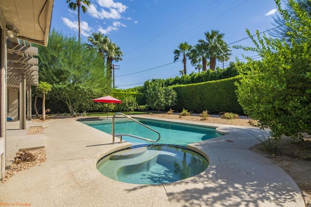 view of pool featuring an in ground hot tub and a patio