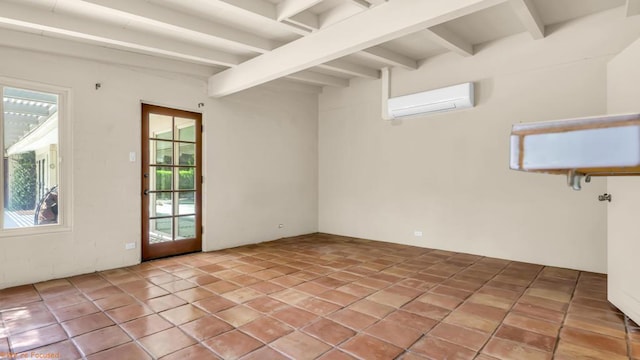 tiled spare room featuring beamed ceiling and a wall mounted air conditioner