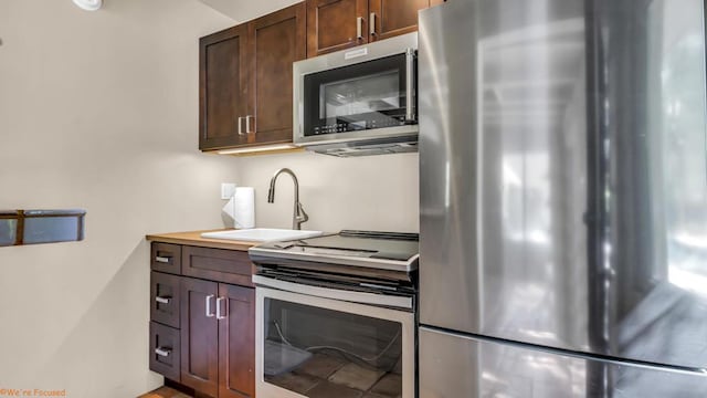 kitchen with sink and appliances with stainless steel finishes