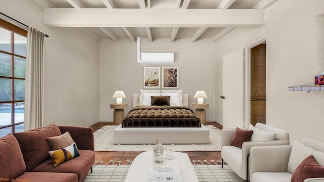 bedroom featuring an AC wall unit, beamed ceiling, and light hardwood / wood-style floors