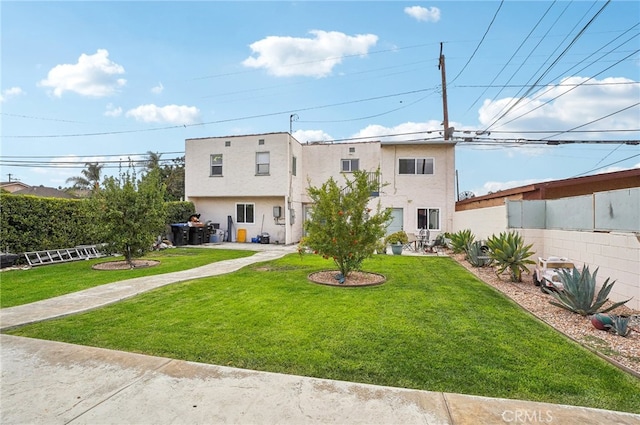 back of property featuring a lawn