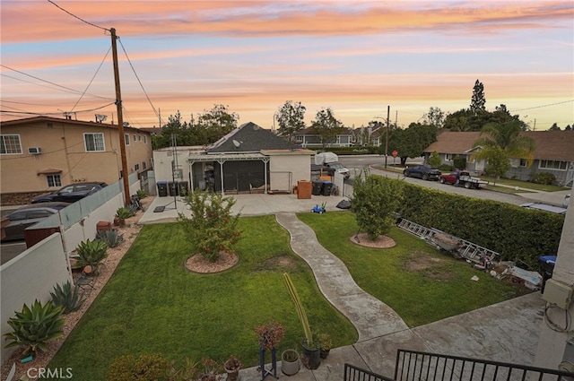 yard at dusk with a patio area