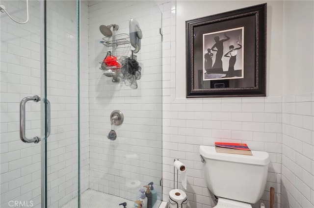 bathroom featuring walk in shower, tile walls, and toilet