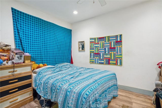 bedroom with light hardwood / wood-style floors and ceiling fan