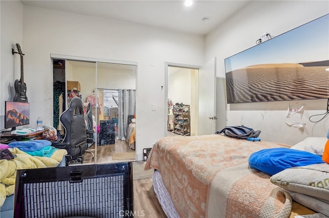 bedroom with a closet and hardwood / wood-style floors