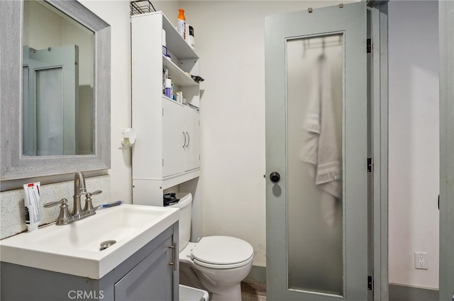 bathroom featuring vanity and toilet