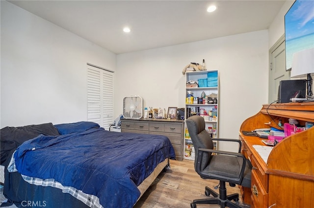 bedroom featuring light wood-type flooring and a closet