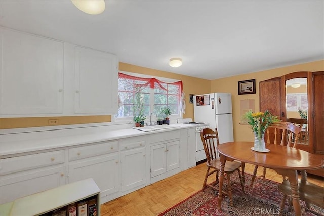 12828 Broyles Trl, Oregon House, CA 95962 - kitchen with freestanding refrigerator, white cabinets, light countertops, and dishwashing machine