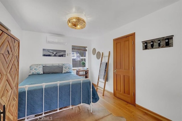 12828 Broyles Trl, Oregon House, CA 95962 - bedroom featuring a wall mounted AC and wood finished floors