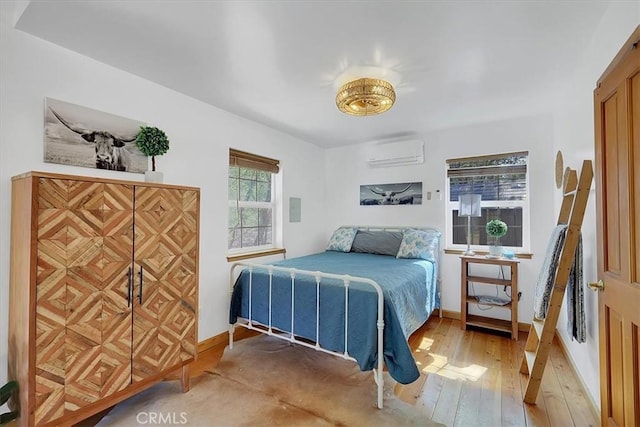 12828 Broyles Trl, Oregon House, CA 95962 - bedroom with a wall mounted AC and light wood finished floors