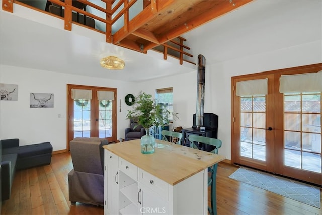 kitchen featuring hardwood / wood-style floors, a wealth of natural light, french doors, and white cabinets