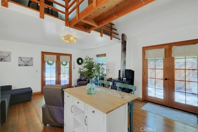 12828 Broyles Trl, Oregon House, CA 95962 - kitchen with french doors, plenty of natural light, white cabinets, hardwood / wood-style flooring, and beam ceiling
