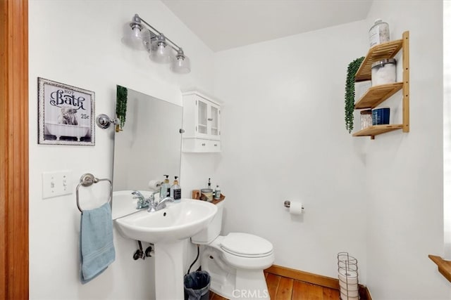 bathroom featuring hardwood / wood-style floors and toilet