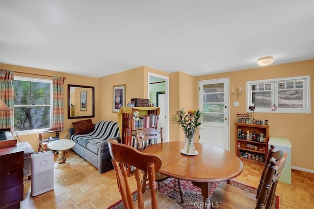 dining room with a wealth of natural light and light parquet floors