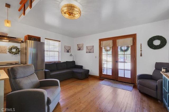 living room featuring french doors, hardwood / wood-style flooring, and a healthy amount of sunlight