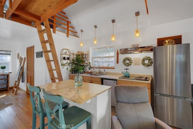12828 Broyles Trl, Oregon House, CA 95962 - kitchen with stainless steel appliances, exhaust hood, healthy amount of natural light, and light countertops