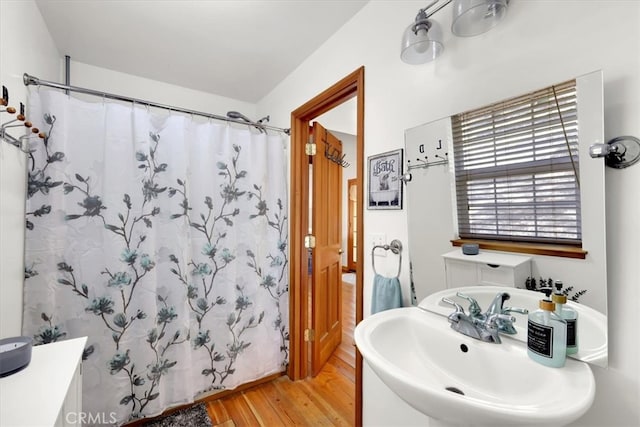 bathroom featuring a shower with shower curtain, wood-type flooring, and sink