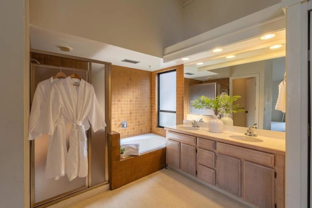 bathroom with vanity and independent shower and bath