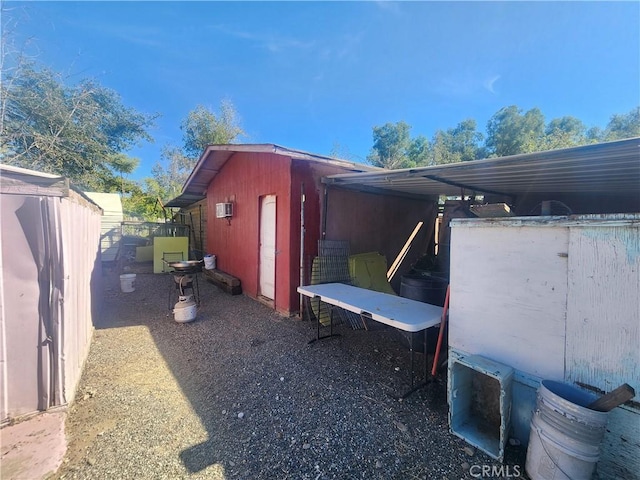 view of side of property with an outdoor structure and a wall unit AC