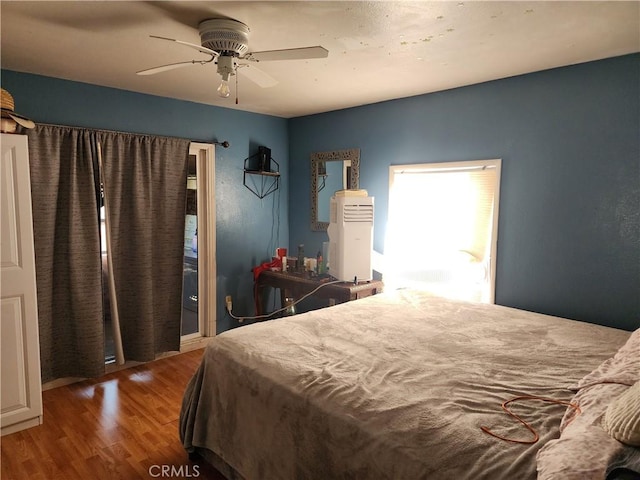 bedroom with ceiling fan and dark hardwood / wood-style floors