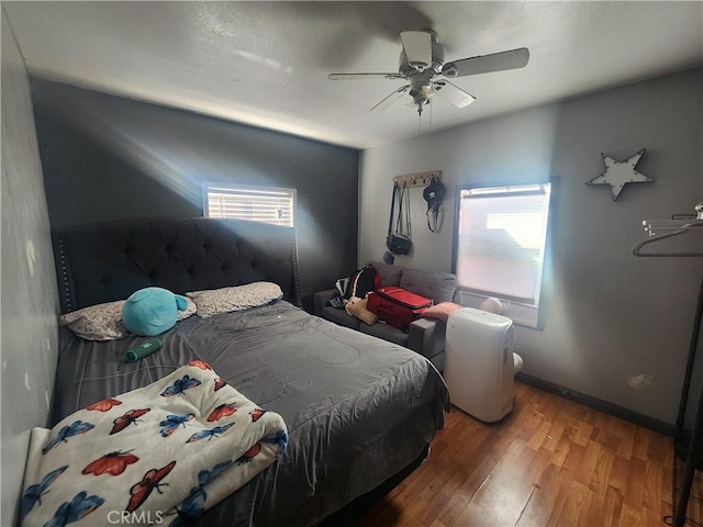 bedroom with hardwood / wood-style flooring and ceiling fan