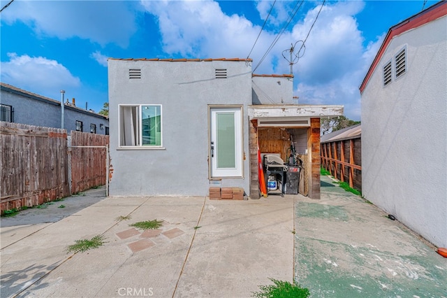 back of property with a patio