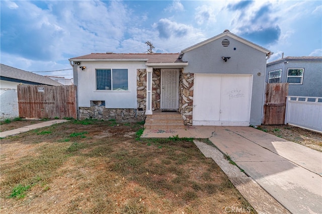 view of front of property with a front yard and a garage